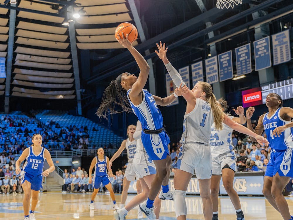 <p>Oluchi Okananwa attempts a layup over North Carolina's Alyssa Ustby.&nbsp;</p>