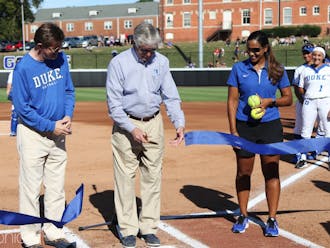 Duke President Vincent Price, vice president and director of athletics Kevin White and head softball coach Marissa Young cut a ribbon to open Saturday's landmark game.