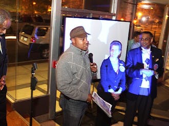 Re-elected Durham Mayor Bill Bell, left, shares the podium with John White, right, director of public policy at the Greater Durham Chamber of Commerce, at Beyu Cafe during the election celebration Tuesday night.