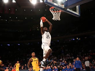 Mark Mitchell (17 points) skies for the dunk in the second half of Duke's win over Iowa at Madison Square Garden.