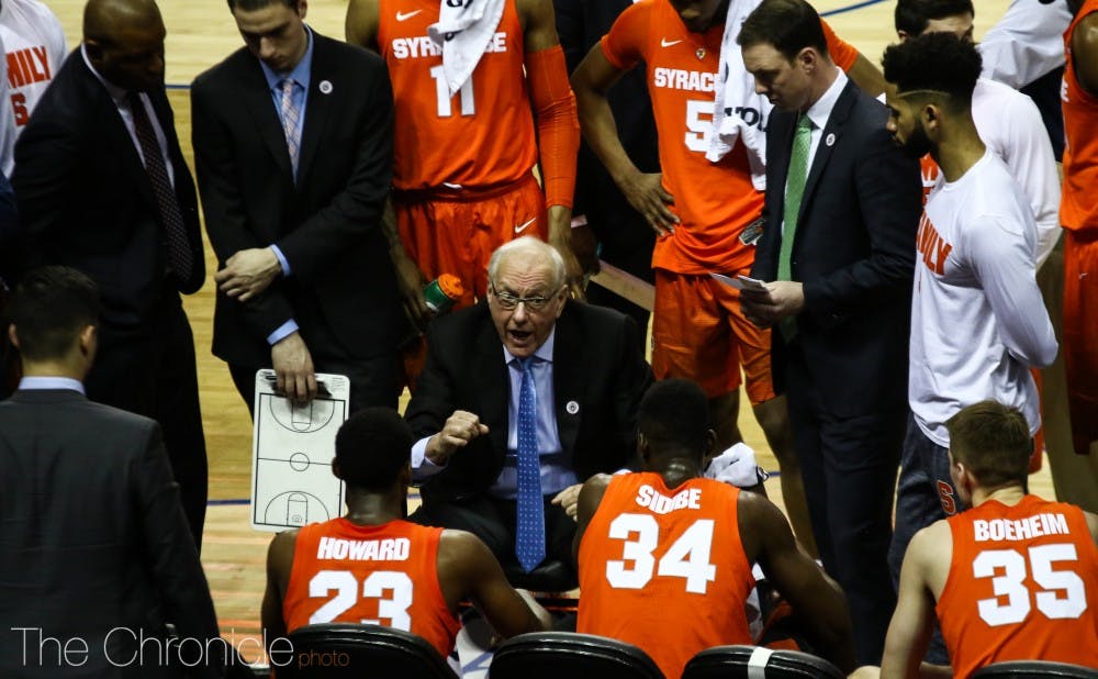 Syracuse head coach Jim Boeheim talks with his squad during a first half time out. 
