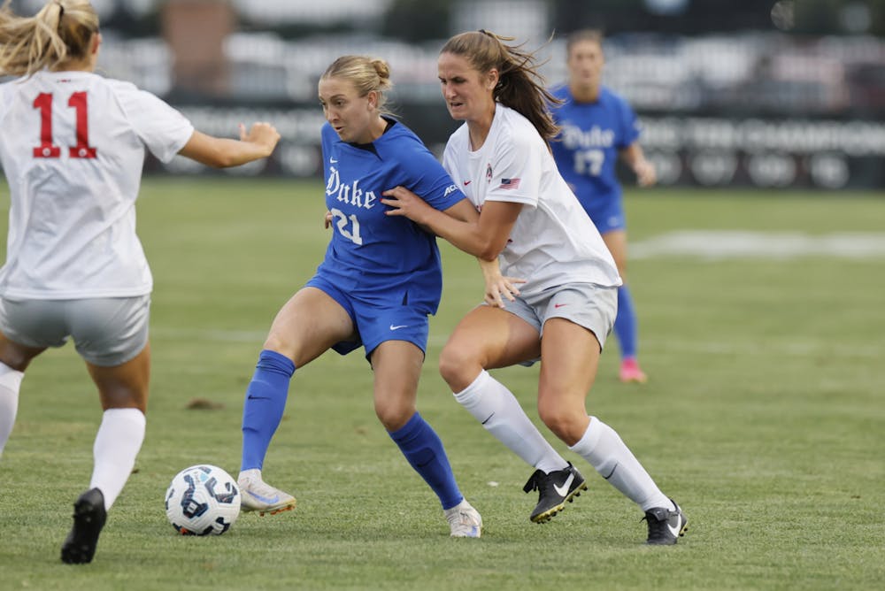 <p>Katie Groff fights off multiple Buckeye defenders in Duke's contest against Ohio State.&nbsp;</p>