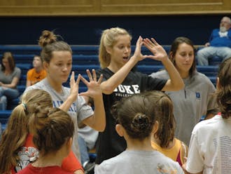 Christina Vucich (center) and the Duke volleyball team have made a habit of holding camps for young girls, and will hold another one Saturday afternoon.