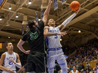 Tyrese Proctor (5) fights for a layup during Duke's win against Dartmouth.