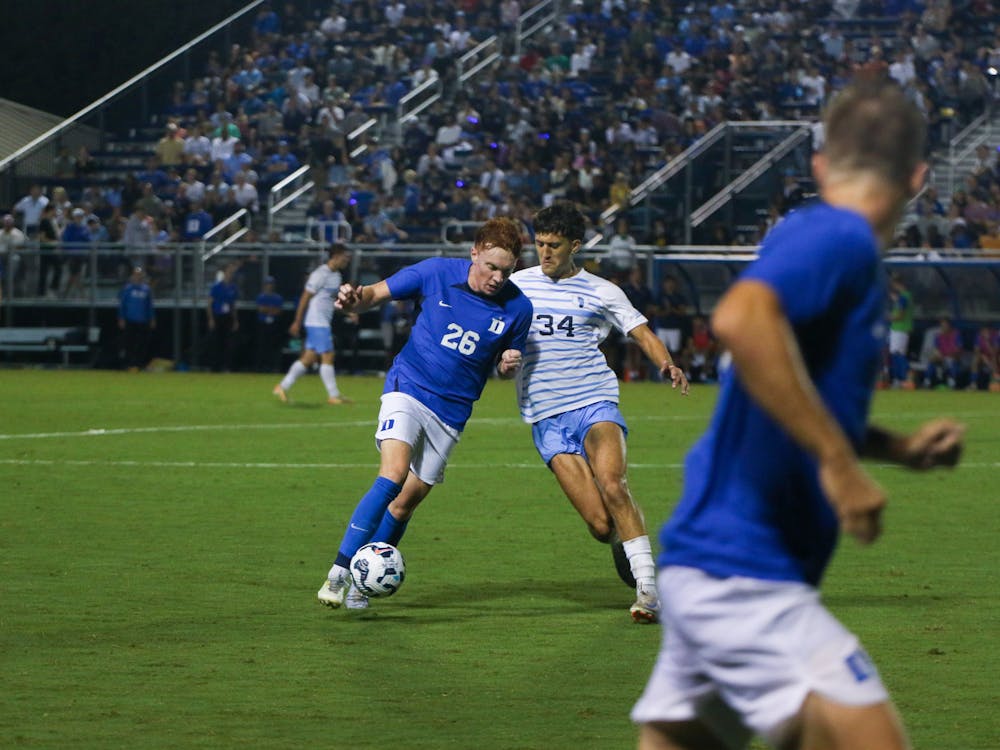 Duke men's soccer's Adam Luckhurst fights forward in what would ultimately be a defeat against North Carolina.