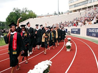Members of the undergraduate Class of 2010 wave to friends and family as they walk to their seats.
