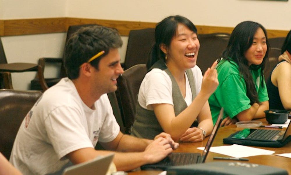 DUU Chief Financial Officer Ben Condon (left) and President Yi Zhang share a laugh at Tuesday’s DUU meeting. At the meeting, the union finalized its 2010-11 budget allocations among its 15 committees.