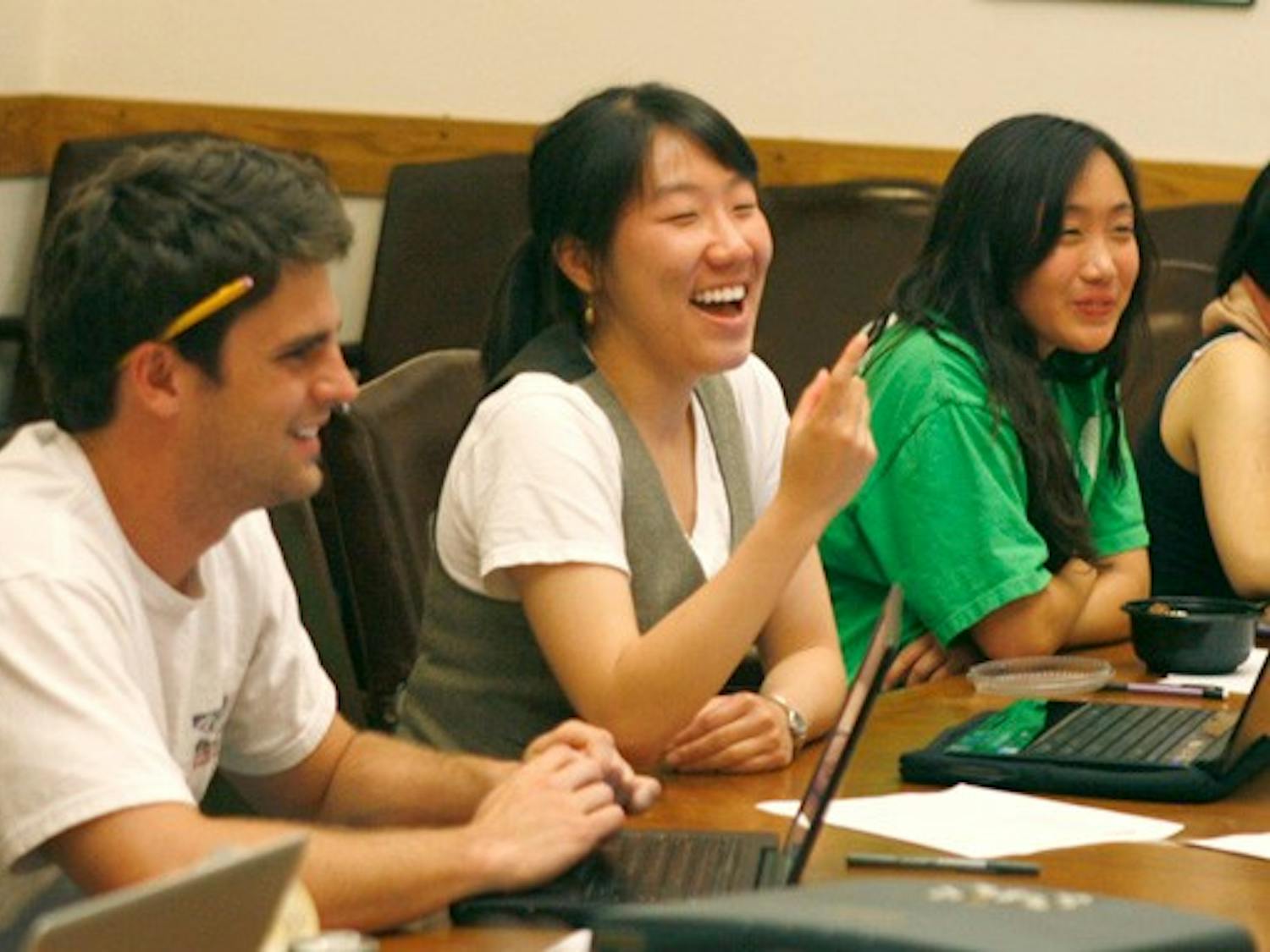DUU Chief Financial Officer Ben Condon (left) and President Yi Zhang share a laugh at Tuesday’s DUU meeting. At the meeting, the union finalized its 2010-11 budget allocations among its 15 committees.