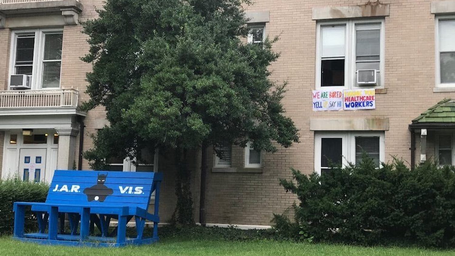 A poster hanging from a window hints at Jarvis dorm's purpose as an isolation space, reading, "We are bored. Yell up to say hi."&nbsp;