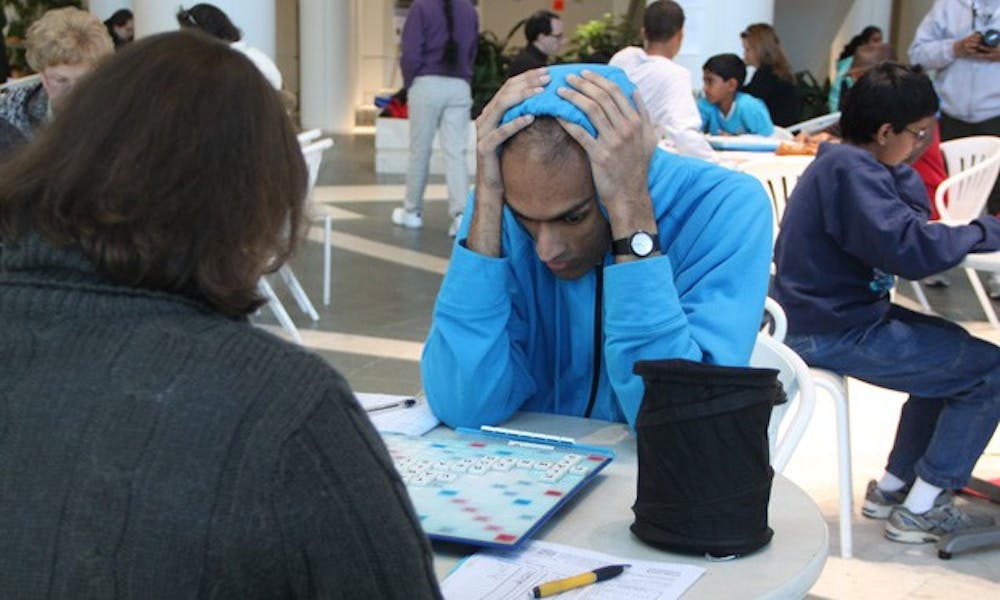 A player surveys the Scrabble board in the North Pavilion of Duke Hospital.
