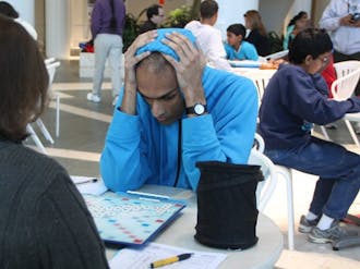 A player surveys the Scrabble board in the North Pavilion of Duke Hospital.