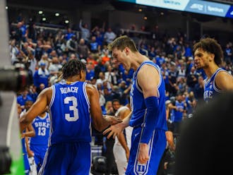 Jeremy Roach and Kyle Filipowski (center) show some emotion in the second half of Duke's ACC tournament win against Virginia.