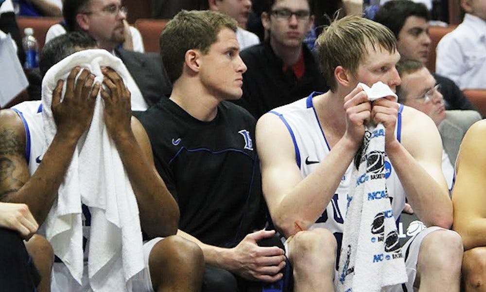Duke seniors Nolan Smith, Casey Peters and Kyle Singler look on as their final game plays out in Anaheim.