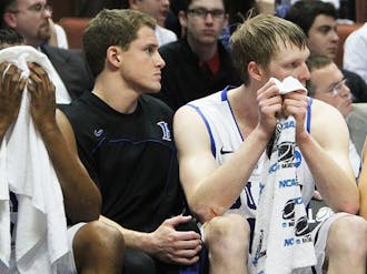 Duke seniors Nolan Smith, Casey Peters and Kyle Singler look on as their final game plays out in Anaheim.
