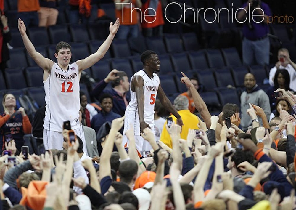 Virginia's Joe Harris, who led the way with 36 points, pumping up the Cavalier fans after they stormed the court. (Photo credit: Caroline Rodriguez/The Chronicle)