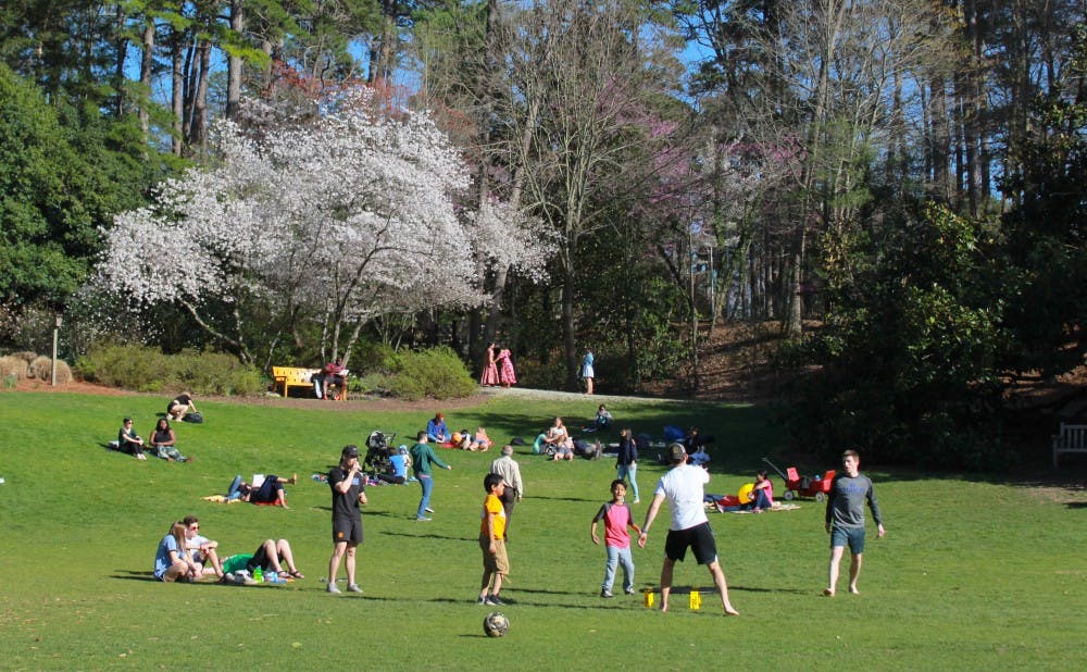 Students and local Durham families enjoy a sunny day in the gardens.