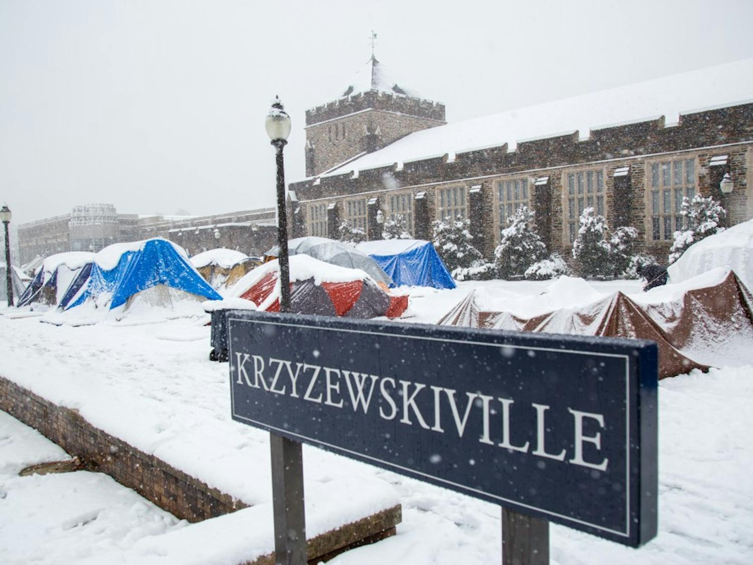 Students build snowmen and salvage their tents weighed down with snow in Krzyzewskivlle.