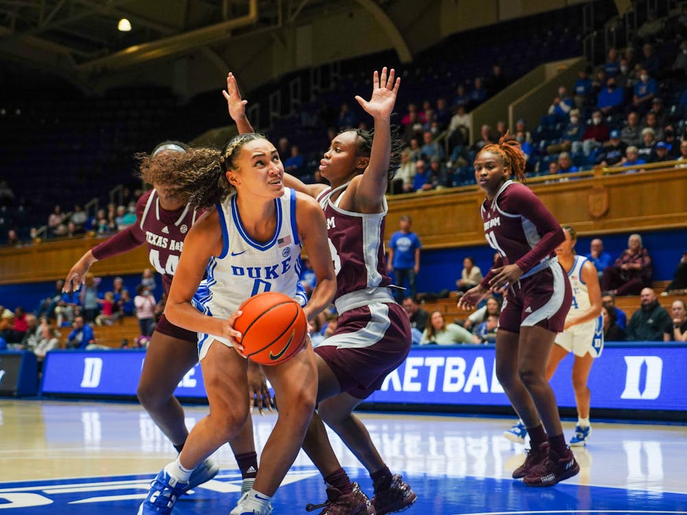 <p>Duke guard Celeste Taylor absorbs contact in the paint in the Blue Devils' 71-52 win at Cameron Indoor Stadium.</p>