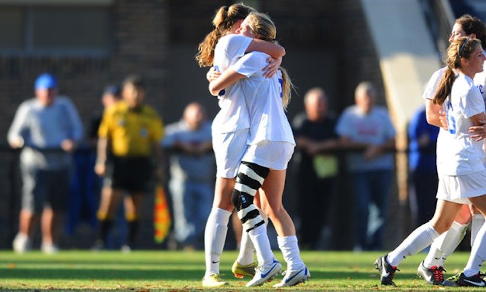Nicole Lipp and Kaitlyn Kerr embrace after Kerr scored the go-ahead goal with just over nine minutes left.