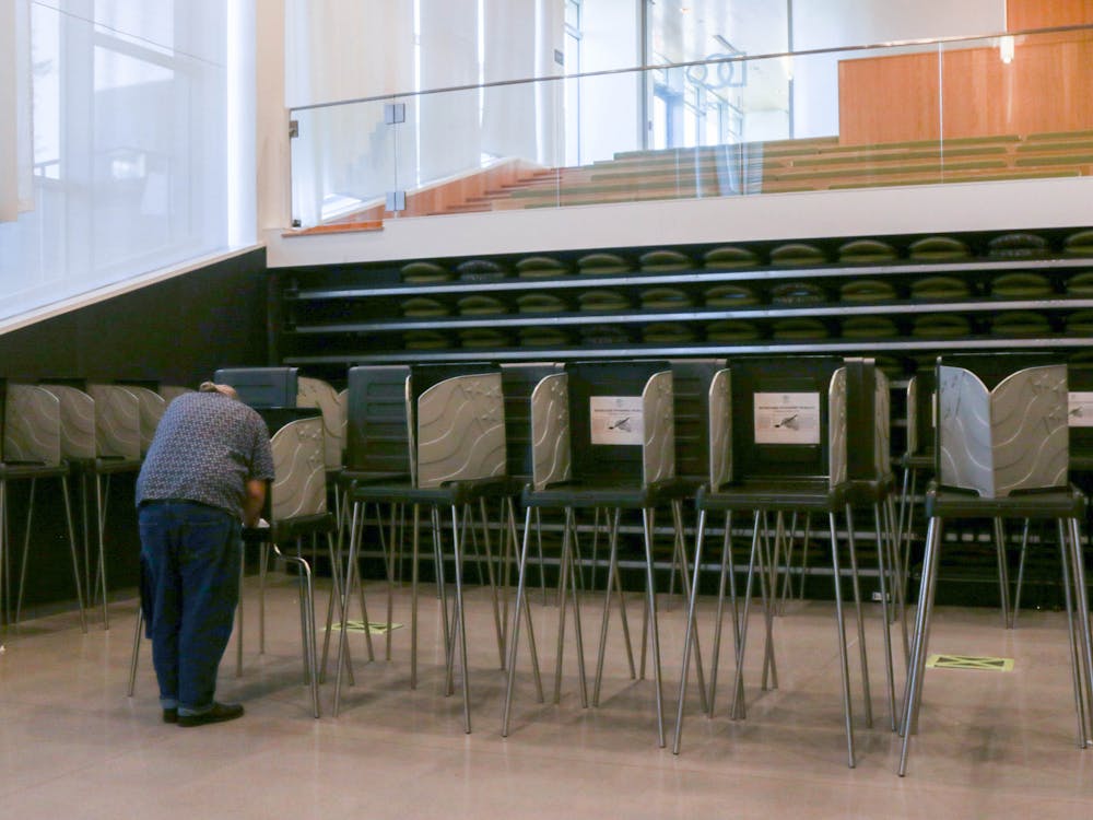 <p>A resident votes at the polling site for Precinct 17 at the Durham Public Library.</p>