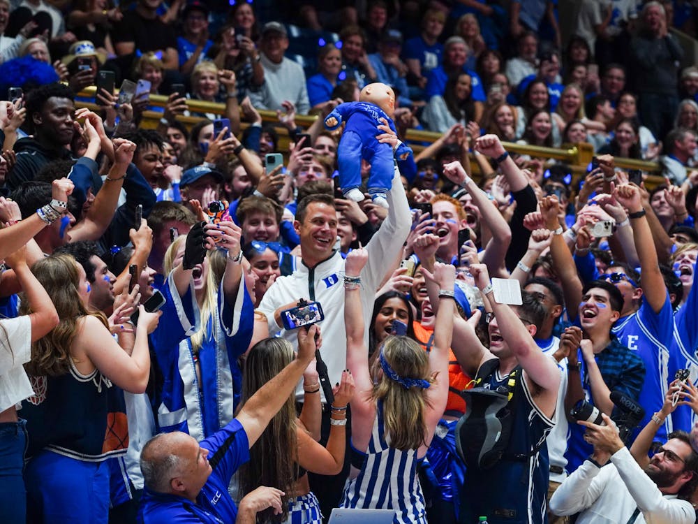 Head men's basketball coach Jon Scheyer stands in the student section during Countdown to Craziness.