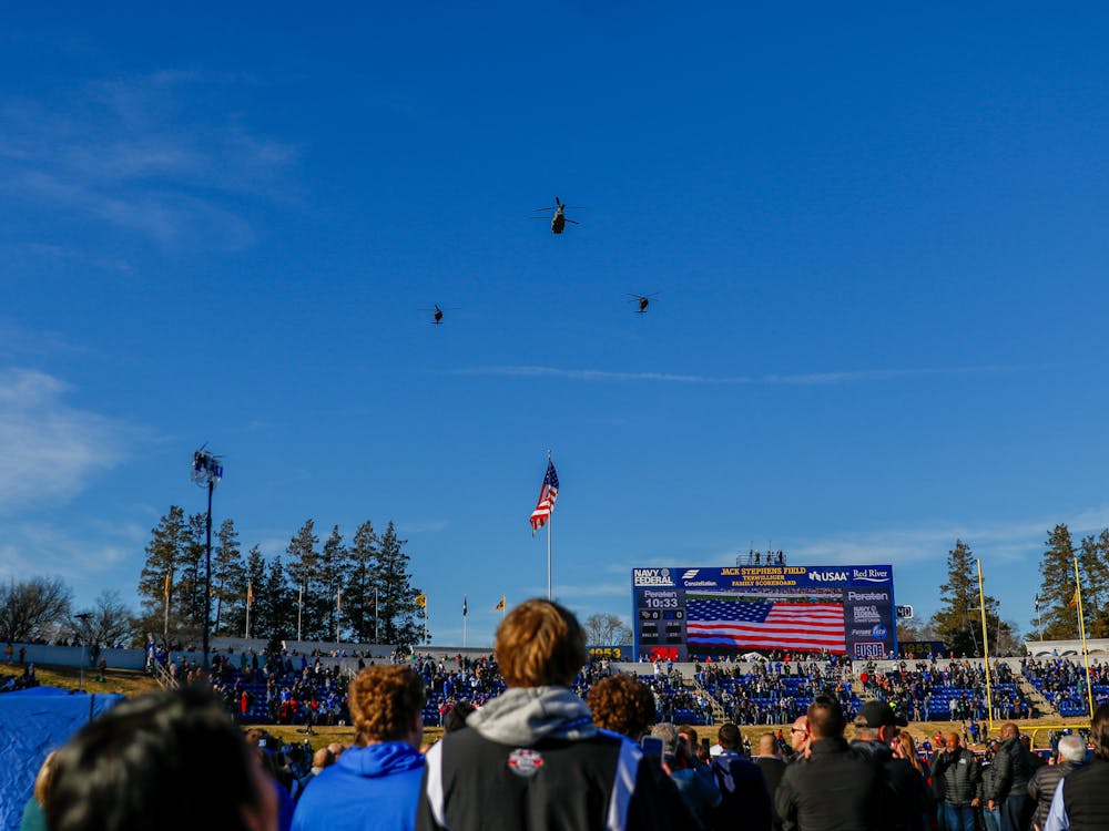 Blackhawk and Chinook helicopters from the 29th Combat Aviation Brigade of the Maryland Army National Guard fly over Navy-Marine Corps Memorial Stadium before kickoff.