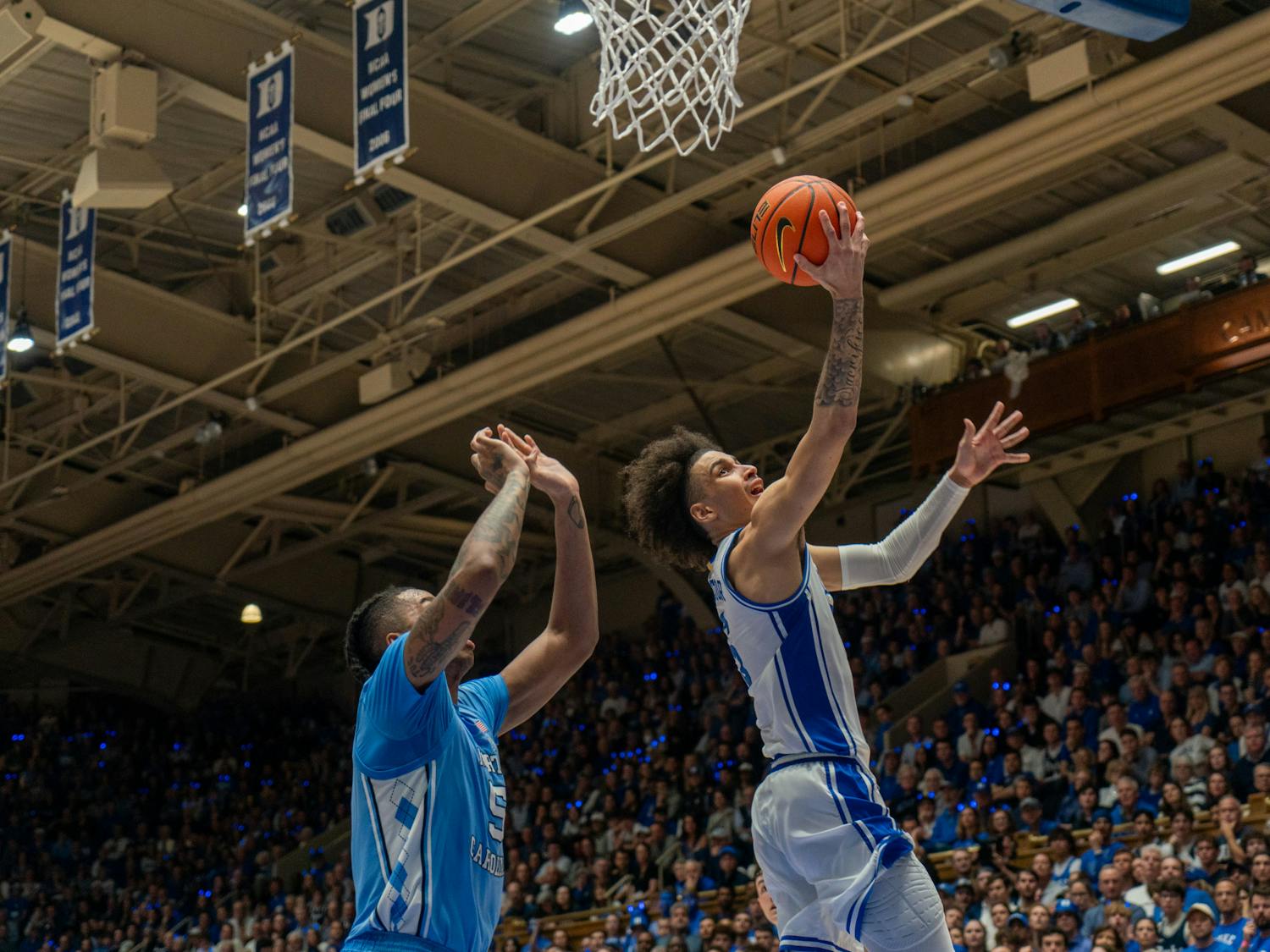 Tyrese Proctor lays the ball up against North Carolina's Armando Bacot. 