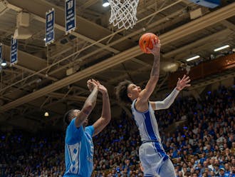 Tyrese Proctor lays the ball up against North Carolina's Armando Bacot. 