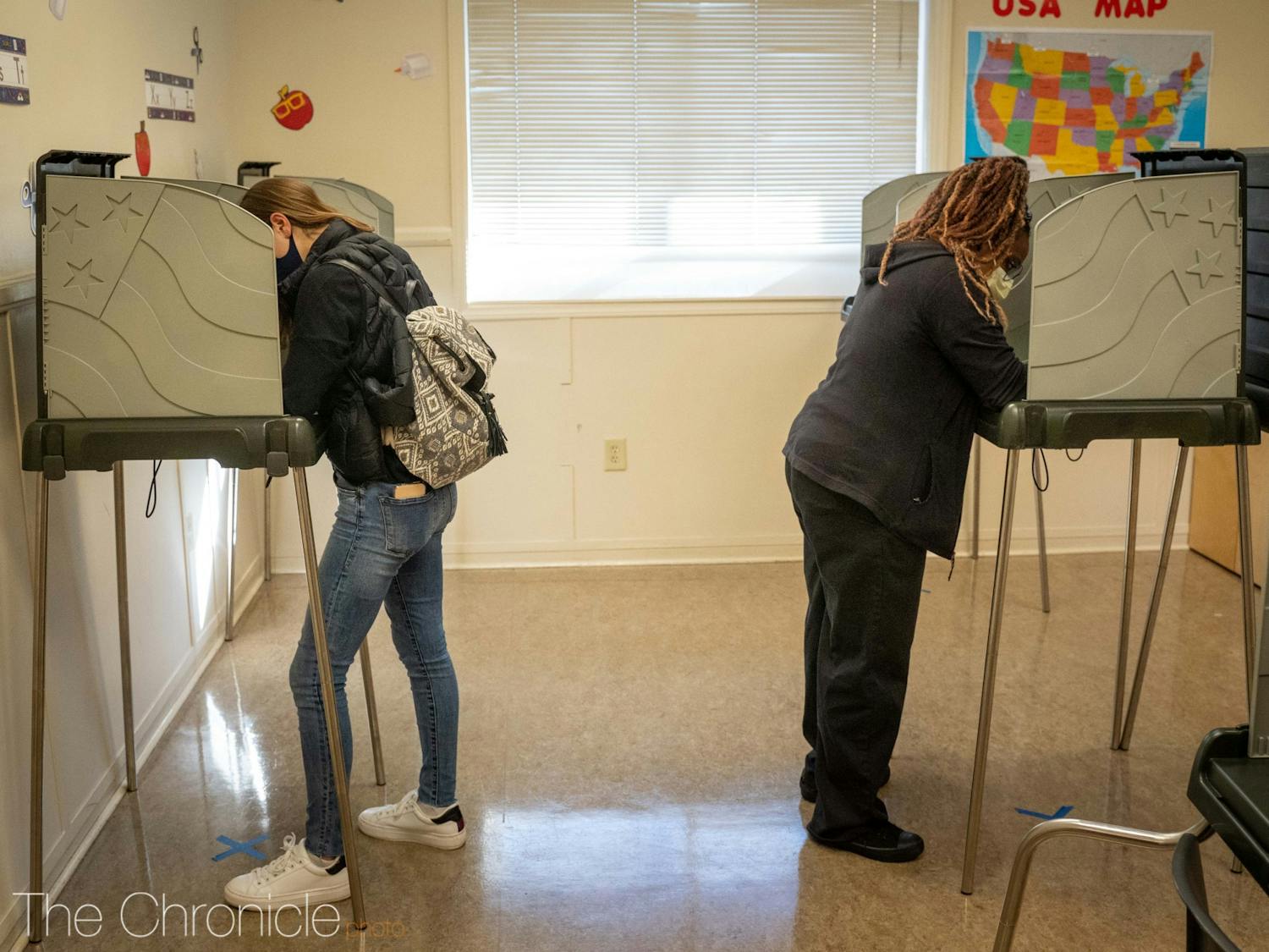 Voters fill out their ballots at the 5th precinct voting site in Durham.&nbsp;