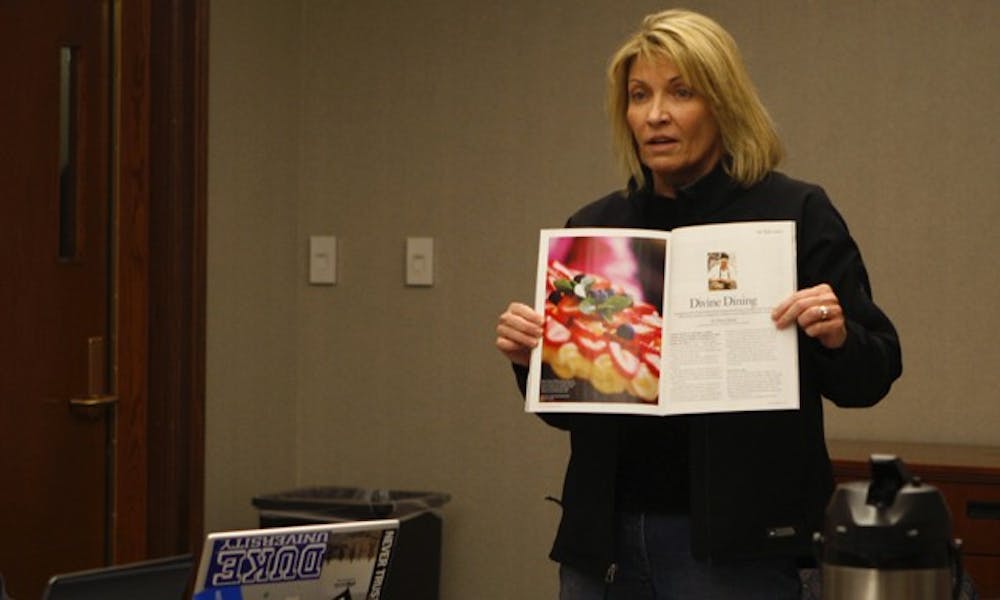 Refectory owner Laura Hall presents a write up of the Refectory from a September issue of “Our State” magazine at Monday’s Duke University Student Dining Advisory Committee meeting.