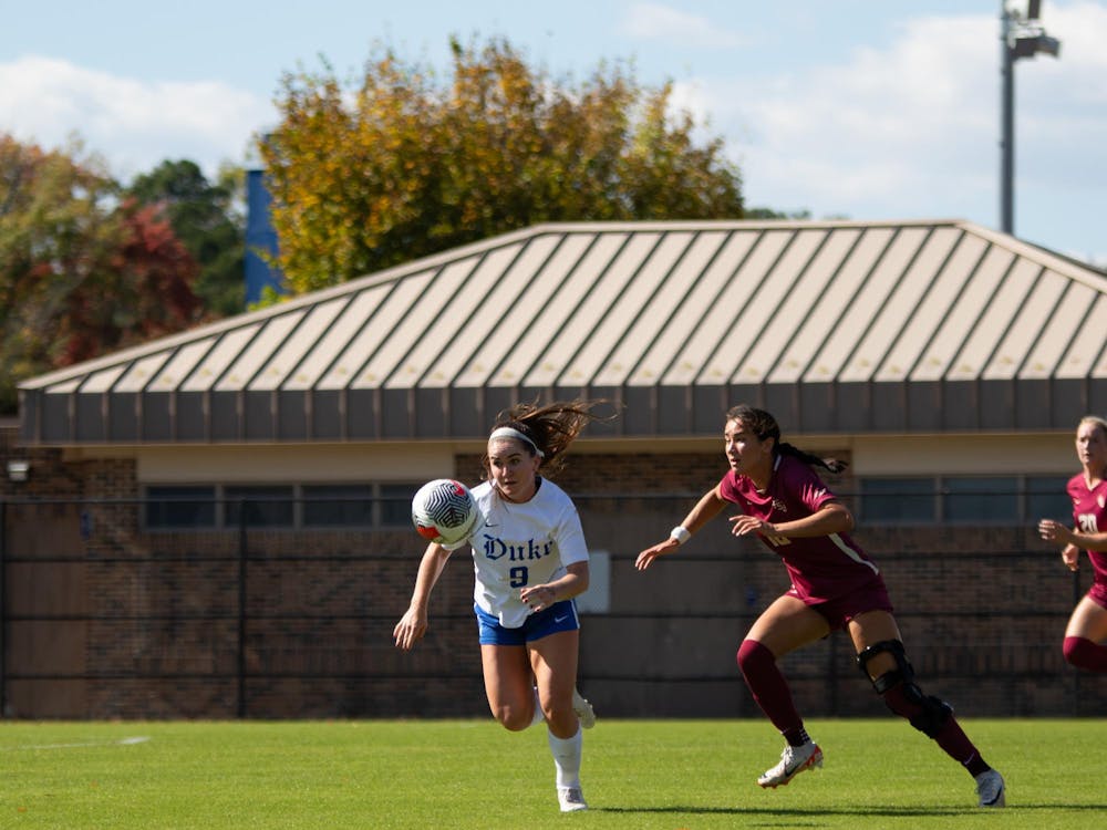Katie Groff races after the ball while being pursued by a Florida State defender.