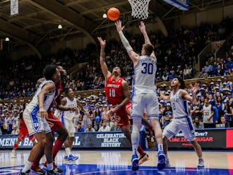 Kyle Filipowski stands tall to deter a shot during Duke's win against Louisville.