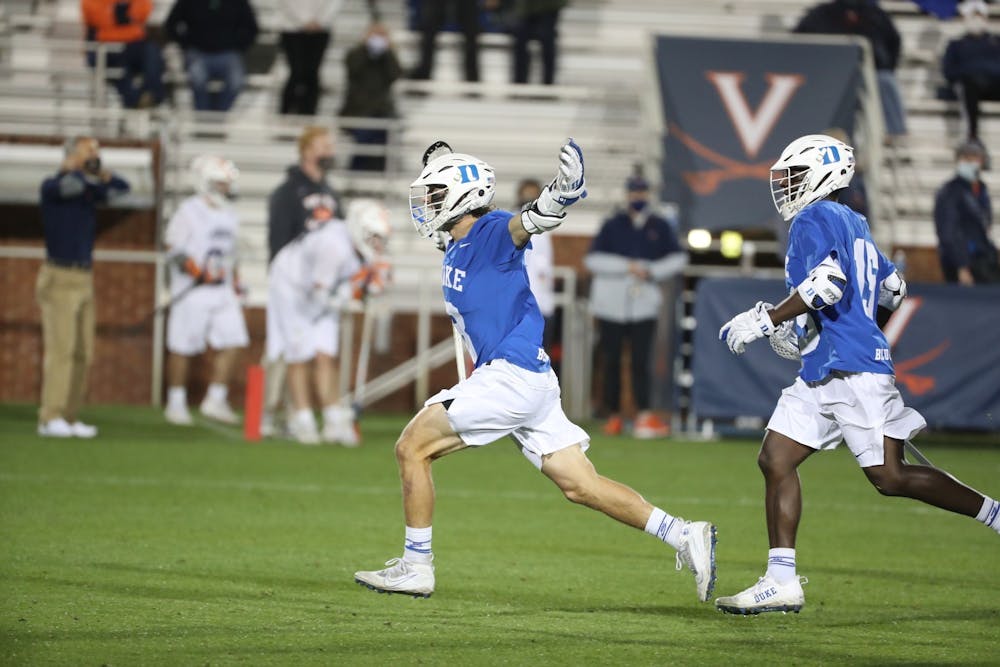 Joe Robertson (left) and Nakeie Montgomery (right) are set to return for one last season with Duke men's lacrosse next spring.