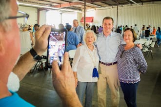 Dan McCready, Trinity '05, takes a photo with supporters after a rally in Lumberton. 