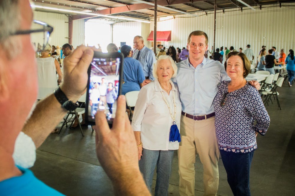 Dan McCready, Trinity '05, takes a photo with supporters after a rally in Lumberton. 