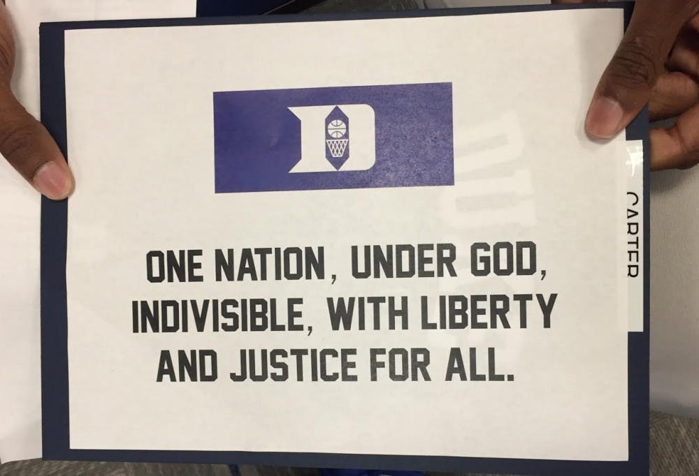 The Blue Devils had this sign in their locker room to represent what they stand for during the national anthem.