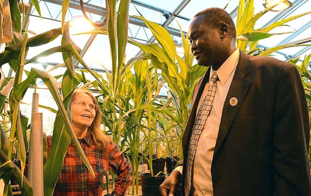Adjunct professor of biology Mary Eubanks shows Akec Khoc, South Sudanese ambassador to the United States, a strain of maize that could boost the country’s agricultural capabilities.