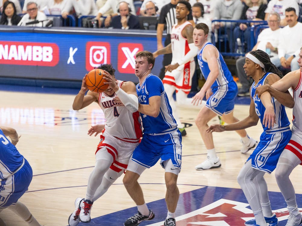 Cooper Flagg defends Arizona's Trey Townsend. 