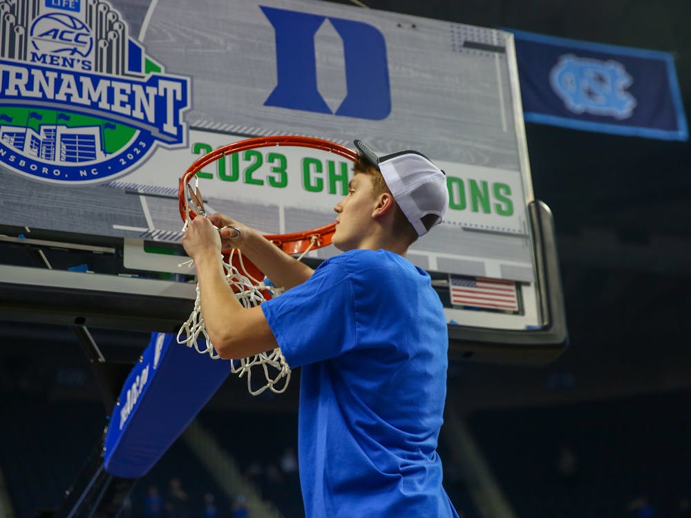 Jaden Schutt cuts the nets after Duke's ACC tournament triumph.