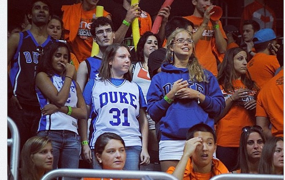 A photo from DukeBluePlanet of Michelle Picon and her friends at the Miami game captioned "Found brave Duke fans in the Miami student section."