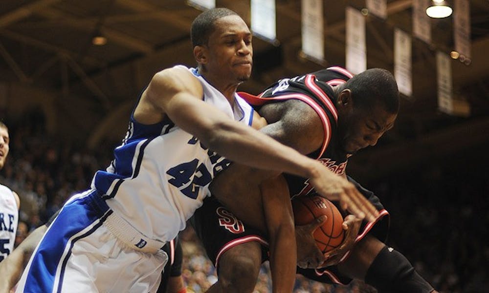 Duke outrebounded a big and athletic St. John’s squad Saturday, 41-31. Here, Lance Thomas, who finished with eight boards, battles for a rebound with the Red Storm’s Dele Coker.