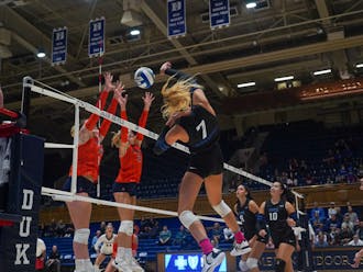 Senior outside hitter Gracie Johnson spikes a shot against Virginia Sunday evening. The Blue Devils earned their first ACC win in a four-set affair.