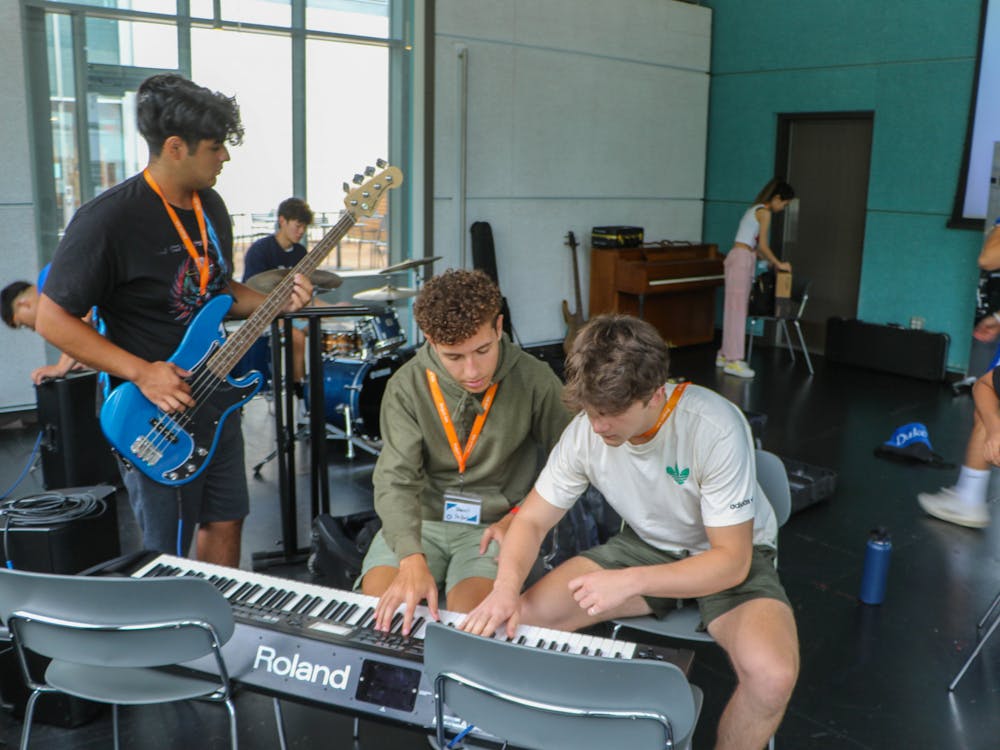 <p>From right: First-years Andrew Spong and Daniel Rodriguez-Florido play the piano together on Aug. 22 in Project Arts, alongside Justin Garcia on the bass guitar.&nbsp;</p>