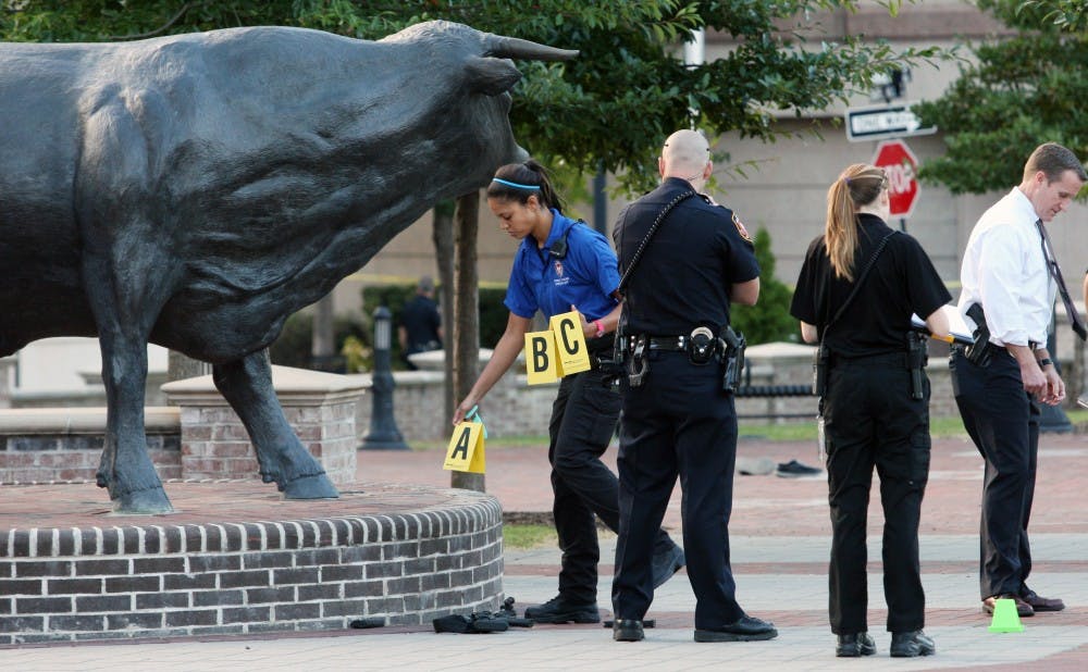 A crime scene investigator marks evidence at the site of the shooting.