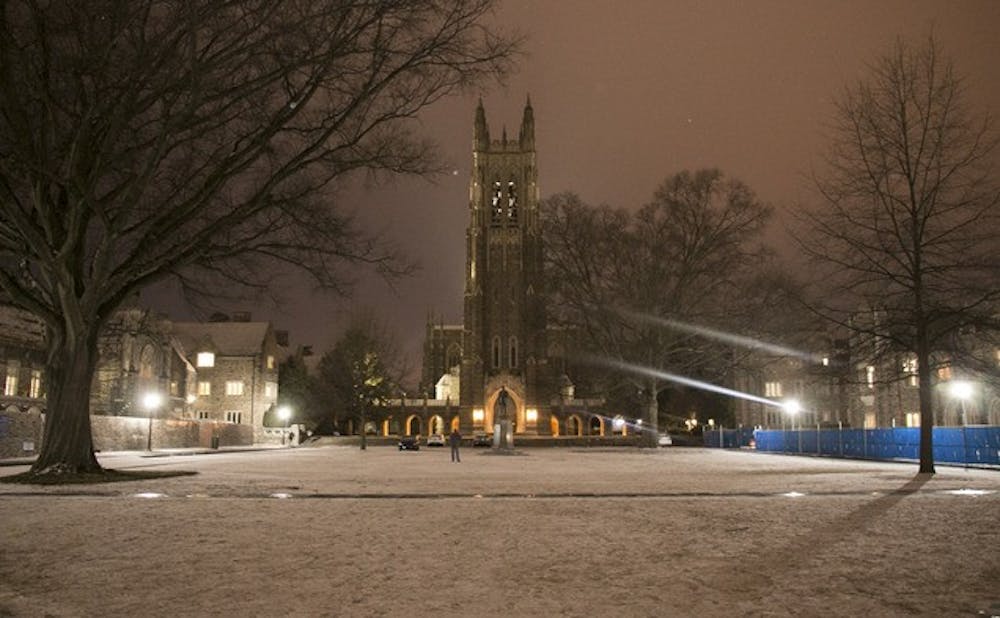 Snow settles over the Chapel Quadrangle Monday evening.