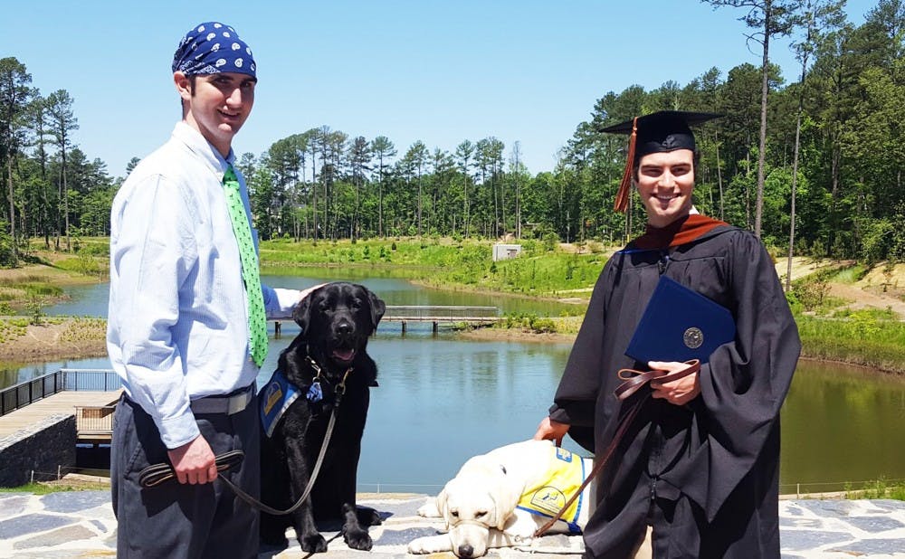 <p>Graduate student Austin Allen (right) has been training his service dog Martin for 13 months and inspired junior Erin Weingarten to begin raising service dogs on Duke’s campus.</p>