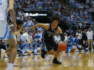 Tyrese Proctor surges forward with the ball against North Carolina.