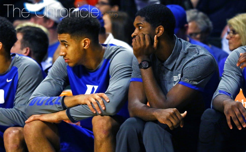 Chase Jeter and Amile Jefferson watch from the sideline Monday&nbsp;as the Blue Devils tried to piece things together with a short bench against the Hurricanes.