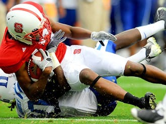Duke safety Matt Daniels (40, left) tackles an N.C. State player in the Blue Devils’ 49-28 victory Saturday. The Duke defense held the Wolfpack offense scoreless in the second half after giving up 21 points in the first two quarters.