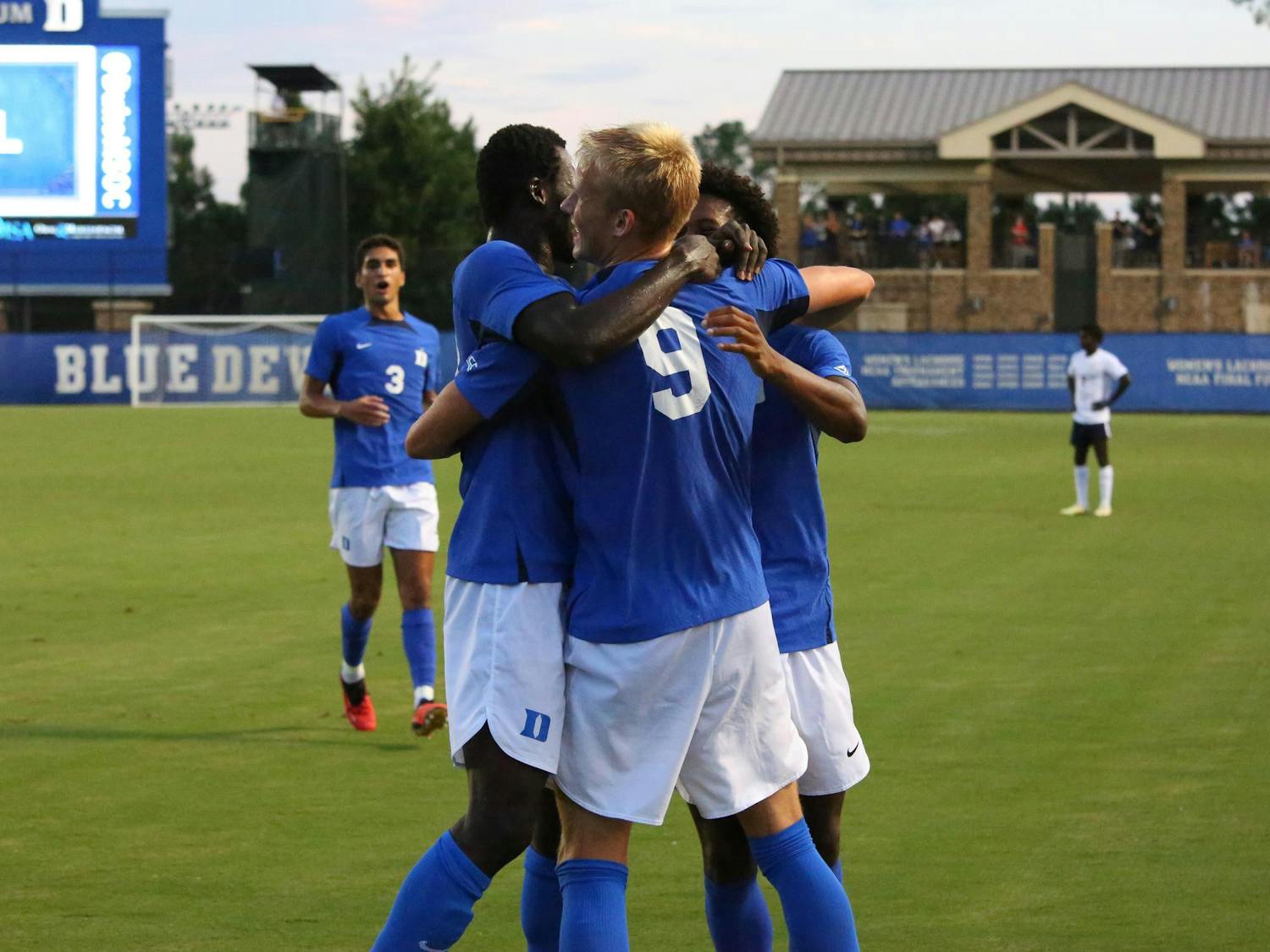 The Blue Devils, including Ulfur Bjornsson and Forster Ajago, embrace to celebrate Duke's 2-0 win against Virginia.